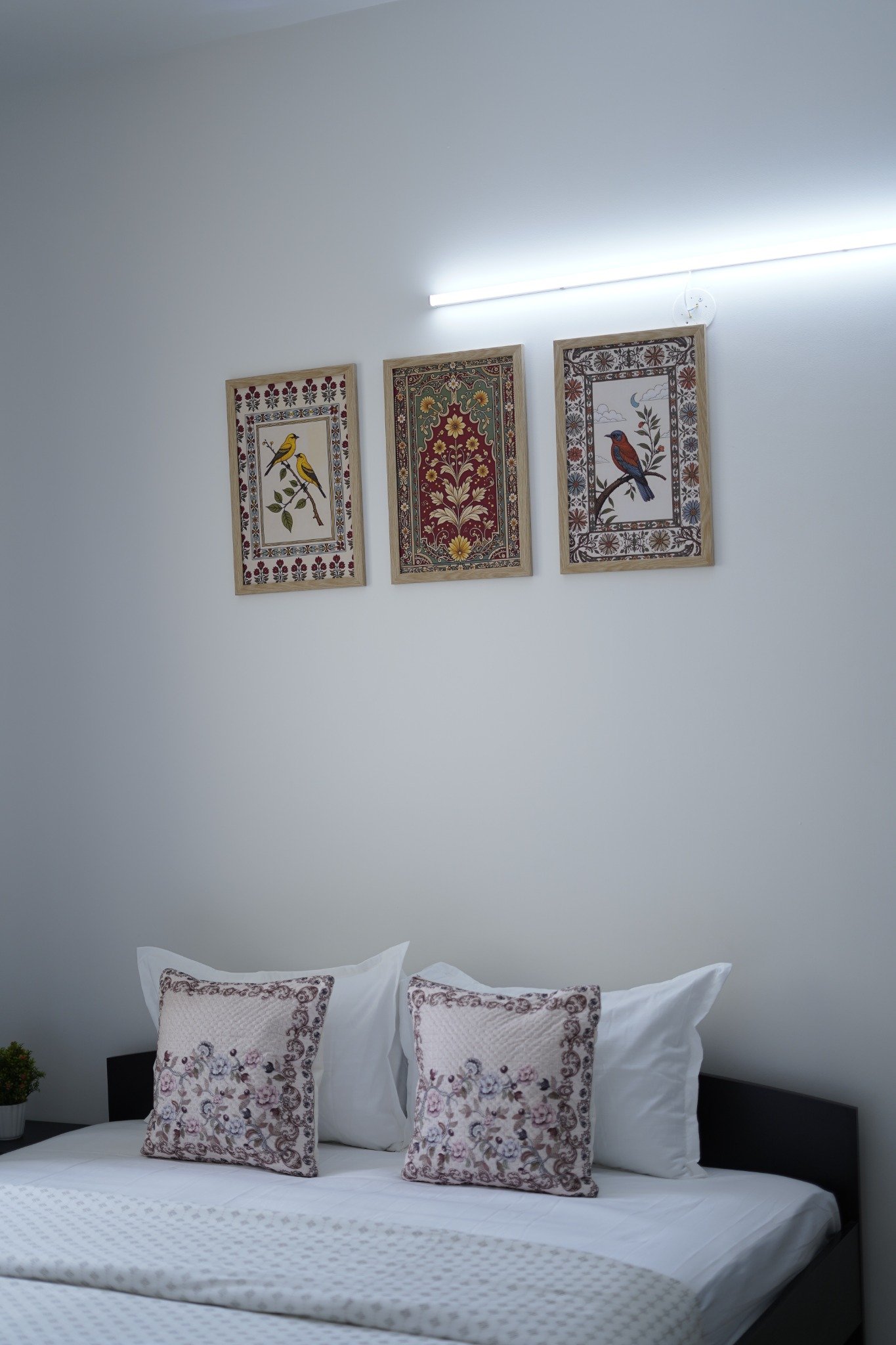 Bedroom with framed artwork at SVP Corporate Suites